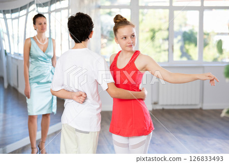 Passionate teen dancers, girl and boy practicing ballroom dancing in studio 126833493