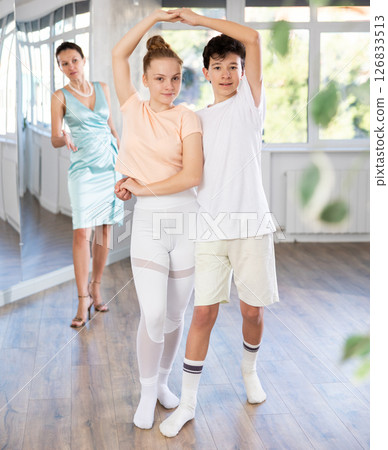 Girl and boy dancing slow ballroom dance in choreography studio Girl and boy dancing slow ballroom dance in choreography studio 126833513