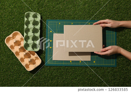 Drawing and paper materials for upcycling in hands on green background, top view Drawing and paper materials for upcycling in hands on green background, top view 126833585