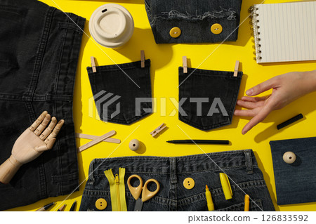 Tools, materials for upcycling and hand on yellow background, top view 126833592