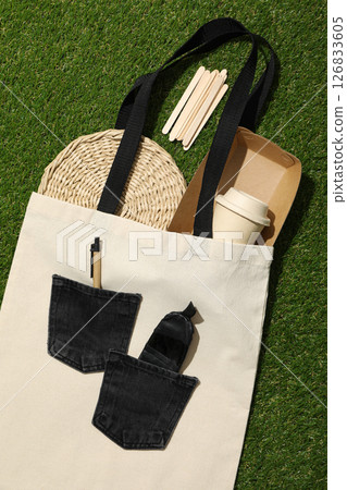 Cotton bag with paper cup, box and tray on green background, top view 126833605