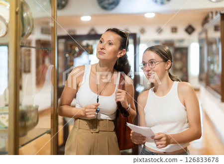 Woman and teenage girl looking at exhibition of tableware Woman and teenage girl looking at exhibition of tableware 126833678