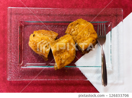 Top view of Madrid torrijas on burgundy background Top view of Madrid torrijas on burgundy background 126833706