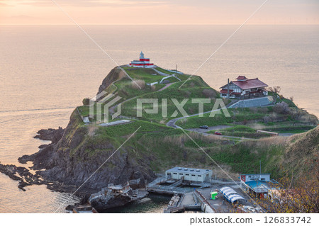 Cape with a lighthouse, early morning sunrise 126833742