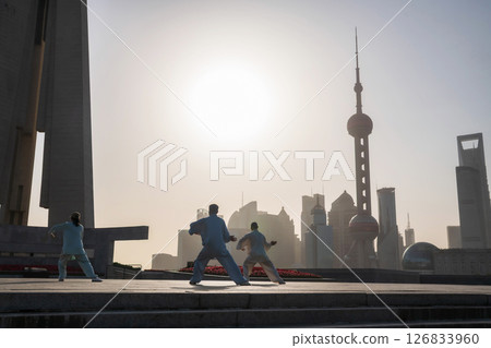 Chinese people practice Tai Chi at People Heroes Tower at sunrise, Shanghai 126833960