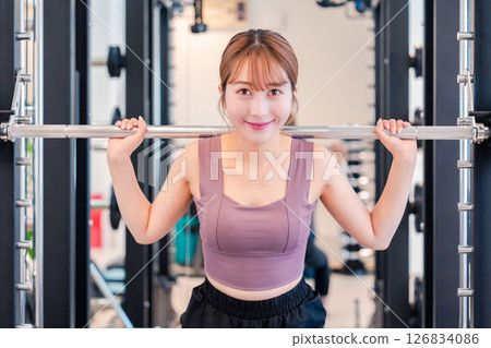 運動型的年輕女子在健身房鍛煉 運動型的年輕女子在健身房鍛煉 126834086