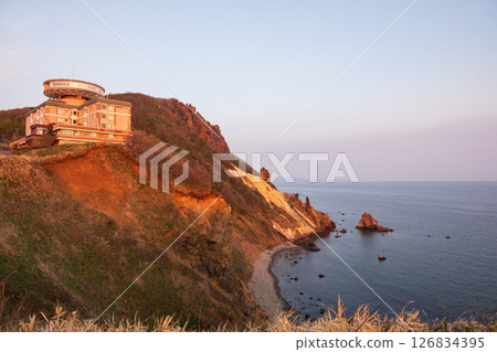 Coastline cliff rocks bathed in the morning sun Coastline cliff rocks bathed in the morning sun 126834395