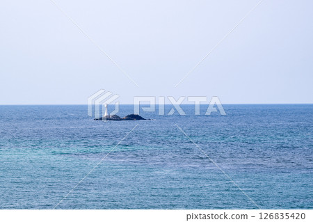 Waves crashing on the beautiful sandy beach of Tsunoshima and the Tsunoshima Bridge 126835420