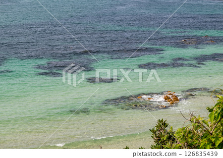 Waves crashing on the beautiful sandy beach of Tsunoshima and the Tsunoshima Bridge Waves crashing on the beautiful sandy beach of Tsunoshima and the Tsunoshima Bridge 126835439