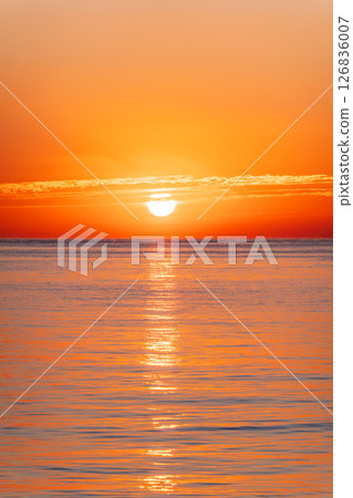 Beautiful red and orange sunrise over the sea. Beautiful red and orange sunrise over the sea. 126836007
