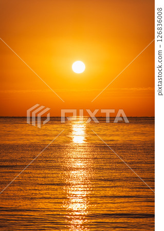 Beautiful red and orange sunrise over the sea. Beautiful red and orange sunrise over the sea. 126836008