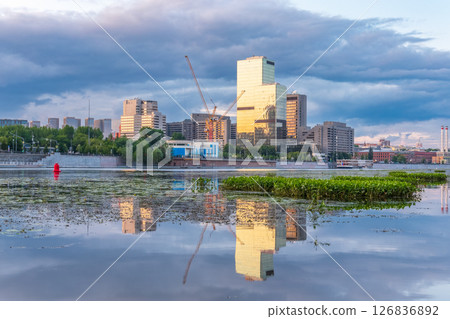 View of Krasnopresnenskaya Embankment in Moscow with reflection in the water. Downtown Moscow, Russia. View of Krasnopresnenskaya Embankment in Moscow with reflection in the water. Downtown Moscow, Russia. 126836892