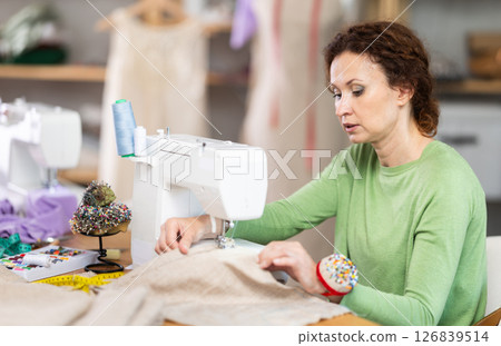 Woman tailor at work in cloth design shop 126839514