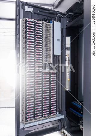 cluster of hard drives stacked inside data storage cabinet 126840166