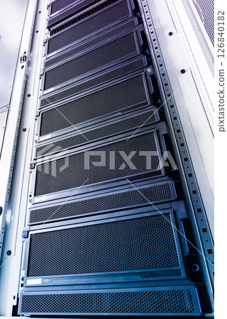 Racks filled with computer hardware inside internet datacenter 126840182