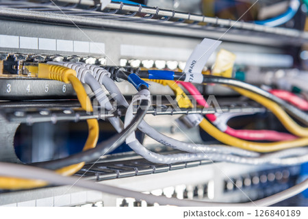 Detail of server room with bunch ethernet cables at the back of Detail of server room with bunch ethernet cables at the back of 126840189