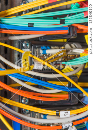 detail of server rack with fiber optic cables attached to front detail of server rack with fiber optic cables attached to front 126840190