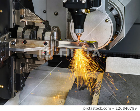Laser cutting process in a manufacturing facility showcasing sparks flying from metalwork Laser cutting process in a manufacturing facility showcasing sparks flying from metalwork 126840789