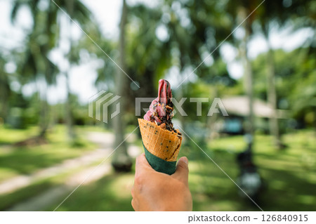 Fresh Fruit Ice Cream in a Waffle Cone,Outdoor Summer Dessert Fresh Fruit Ice Cream in a Waffle Cone,Outdoor Summer Dessert 126840915