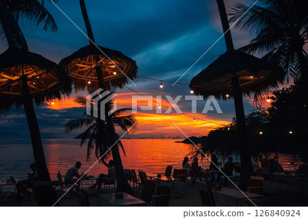 Palm Trees on White Sandy Beach with Island View in Azure Sea 126840924