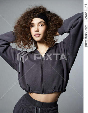 fashionable beautiful young woman in tracksuit of hoodie and trousers 126841061