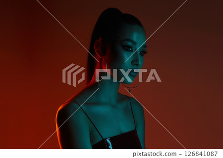 beautiful young woman in color lights 126841087