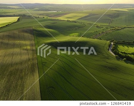 Beautiful spring landscape with field, hills and sunset. Czech Republic - South Moravia (Moravian Tuscany.) Concept for agriculture, travel, environment and nature. 126841419