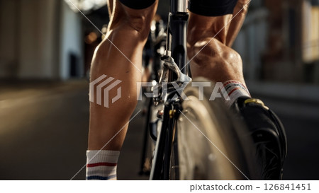 Close-Up of Racing Cyclists Legs Pedaling During Competition Close-Up of Racing Cyclists Legs Pedaling During Competition 126841451
