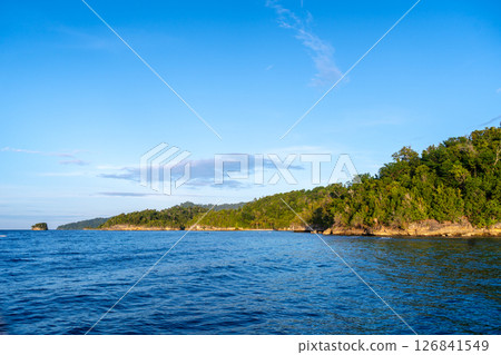 Sunset over Waleakodi Island, Togian archipelago, Sulawesi, Indonesia coastal landscape 126841549