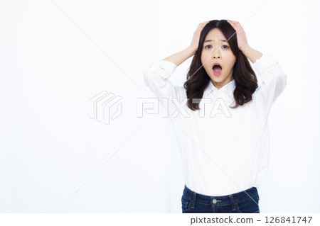 A surprised woman holding her head 126841747