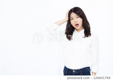 A surprised woman holding her head A surprised woman holding her head 126841749