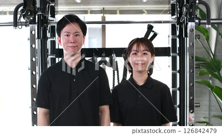 Smiling male and female gym instructors lined up Smiling male and female gym instructors lined up 126842479