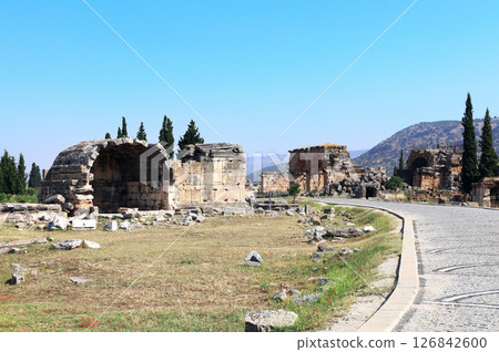 Columns and ruin of ancient building on Frontinus street in ancient Hierapolis, Pamukkale, Anatolia, Turkey. Topic of vacation, travel, trip abroad on vacation, cruises and tours Columns and ruin of ancient building on Frontinus street in ancient Hierapolis, Pamukkale, Anatolia, Turkey. Topic of vacation, travel, trip abroad on vacation, cruises and tours 126842600