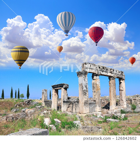 Air balloons and ancient building on Frontinus street, Hierapolis, Pamukkale, Turkey. Topic of vacation, travel, trip abroad, cruises and tours. Balloon flight, famous tourist attraction of Pamukkale Air balloons and ancient building on Frontinus street, Hierapolis, Pamukkale, Turkey. Topic of vacation, travel, trip abroad, cruises and tours. Balloon flight, famous tourist attraction of Pamukkale 126842602