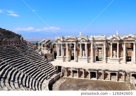 Top view on theater in ancient Hierapolis, Pamukkale, Anatolia, Turkey. Topic of vacation, travel, trip abroad, cruises and tours.  Complex is a prominent symbol of Turkey and a key tourist attraction 126842603