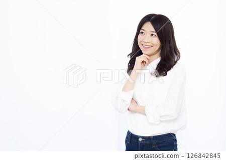 A woman who is thinking with her arms crossed A woman who is thinking with her arms crossed 126842845