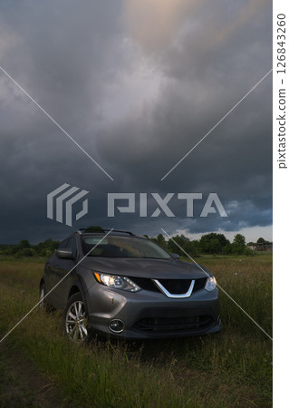 SUV in a Field Under Dramatic Skies SUV in a Field Under Dramatic Skies 126843260