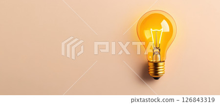 glowing yellow light bulb against soft beige background, symbolizing creativity and ideas 126843319