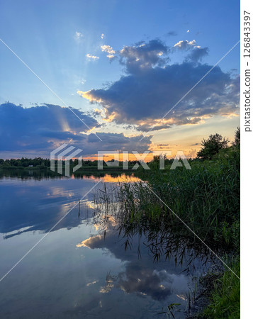 Serene Sunset Reflection Over a Tranquil Lake 126843397