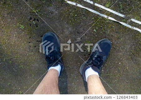 The feet of a man jogging 126843403