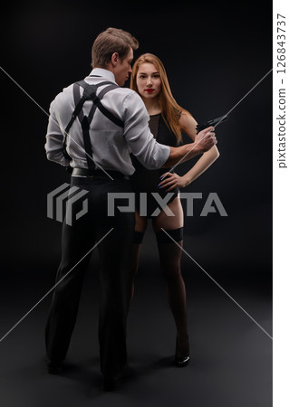 Mysterious encounter between a man and a woman in dark setting with suspense 126843737