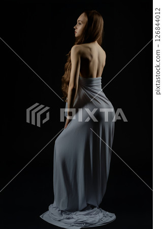 Woman modeling in elegant pose during casting session at studio 126844012