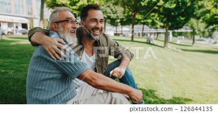 Handsome mature man hugging his older father. Handsome mature man hugging his older father. 126844135