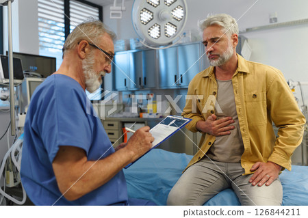 Patient explaing his health issues to older doctor. Patient explaing his health issues to older doctor. 126844211