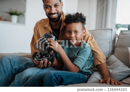Father and son exploring STEM, robotics, and technology together. 126844283