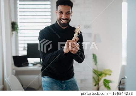 Happy man proudly holding a trophy. 126844288