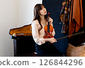 Long-haired woman holding a violin 126844296