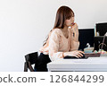A woman operating a personal computer 126844299