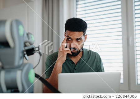 Engineer struggling with a technical problem while building robotic arm. 126844300