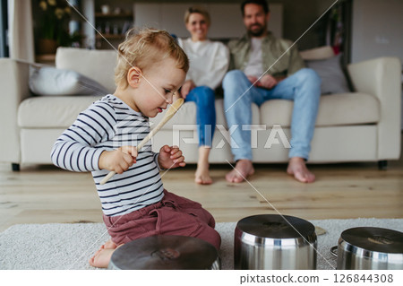 Toddler boy playing drums on kitchen pots 126844308